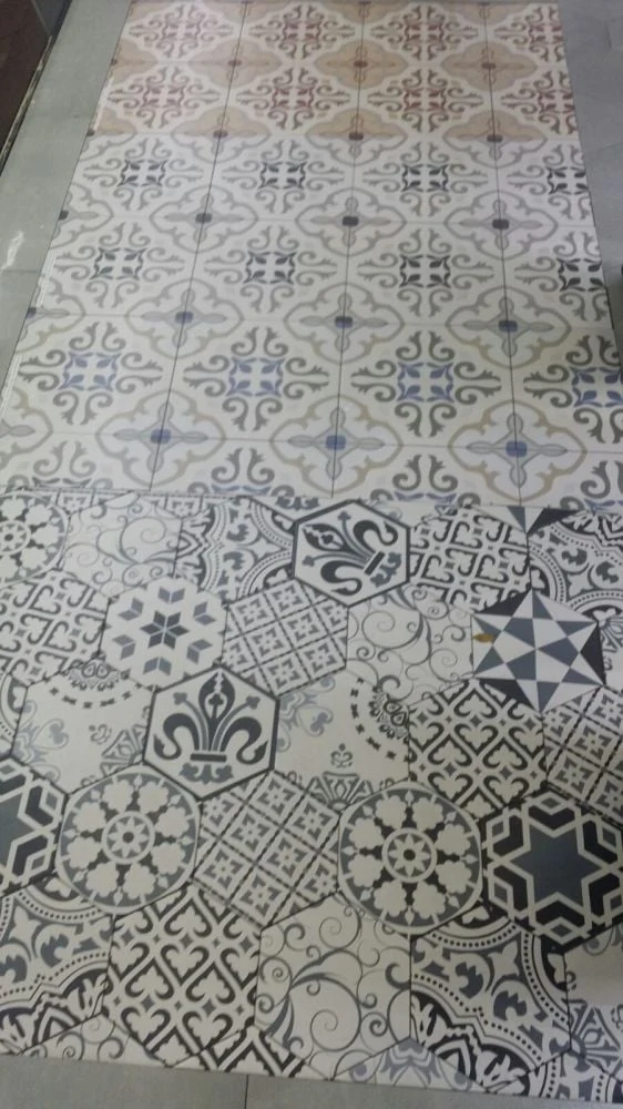 Blue and white patterned tiles on a floor display
